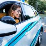 Happy woman learning to reverse car during lesson