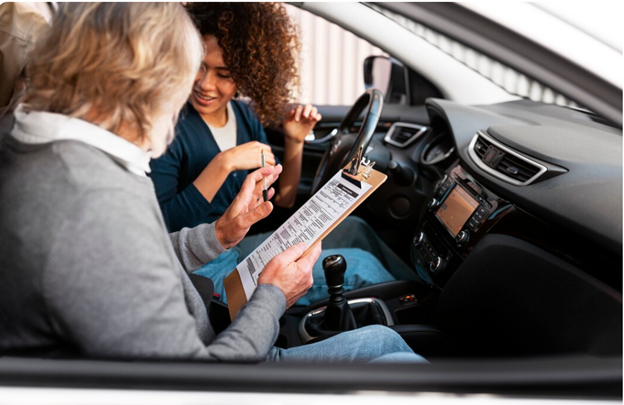 Driving instructor with student in car lesson